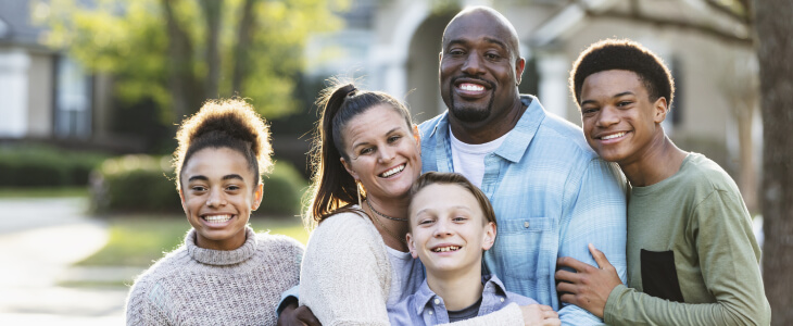 Blended family group photo outdoors